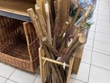a basket of sticks and a bottle of water on the floor