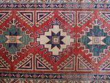an oriental rug with a red, blue, and green design