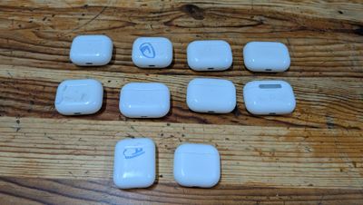 six white electronic devices sitting on a wooden table