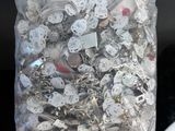 a bag full of silver and white buttons on a table