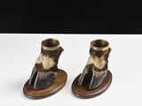 pair of brown and black animal print ankle boots on wooden bases