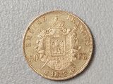 a close up of a gold coin on a white surface