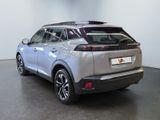 the rear end of a silver suv parked in a room