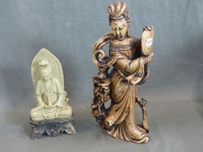 a statue of a woman holding a book and a statue of a statue of a buddha