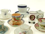 many cups and saucers that are sitting on a table