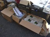 many boxes of newspapers sitting on the ground next to a table