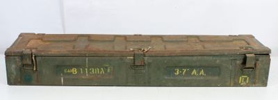 an old green metal box sitting on top of a white table