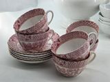 several cups and saucers are stacked on top of each other on a table