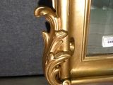 a picture of a gold frame on a table