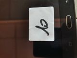 a sticker on the back of a cell phone that says e