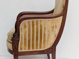 an image of a wooden chair with a striped upholstered back