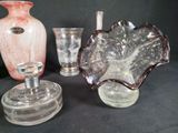 three glass vases and a glass candle holder on a table
