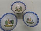 three bowls with pictures of animals on them sitting on a table