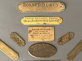 many different types of brass tags on a table