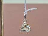 a small crystal pendant hanging from a gold pole