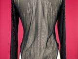 black sheer top on mannequin torso with long sleeves