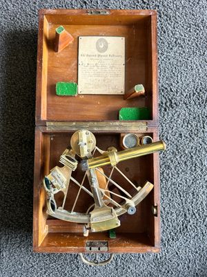 an old wooden box with a brass sexet and other items in it