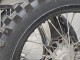a close up of a motorcycle tire on a white surface