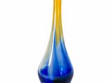a blue and yellow vase sitting on a white surface