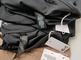a pile of clothing on a table with a price tag