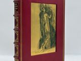 un vieux livre sur lequel figure l'image d'une femme tenant une croix