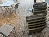 a lot of chairs and tables that are outside