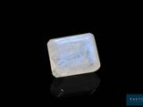 une pierre oplite blanche de forme carrée posée sur une surface noire