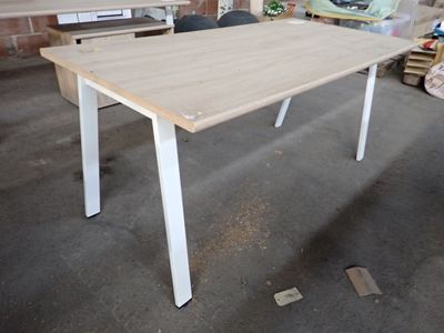 a white table with a wooden top in a room