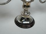 a silver candle holder on a table with a white background