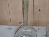 a glass bottle sitting on a marble counter top