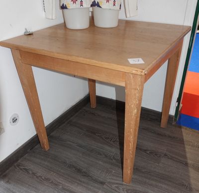 une table en bois sur laquelle sont posés deux pots de fleurs