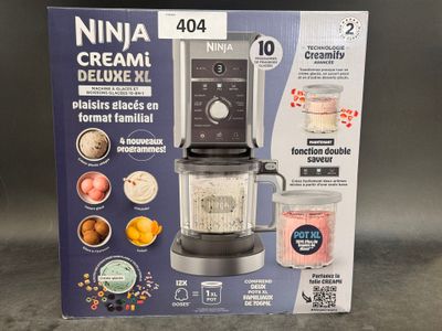 packaging of a blender with a blender in it sitting on a table