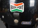 a black helmet with a green, orange, and white logo on it