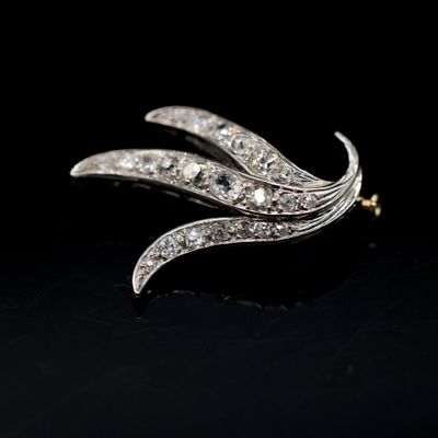 a close up of a diamond broochle on a black surface