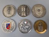 several coins are arranged in a row on a gray surface