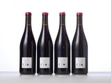 three bottles of wine are lined up on a table