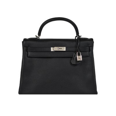 a black leather handbag on a white background