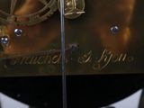 a close up of a clock on display in a museum