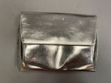 silver leather clutch bag on a gray surface