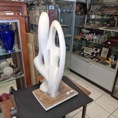 a white sculpture sitting on a small table in a room