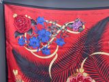 a picture of a red scarf with a floral design on it