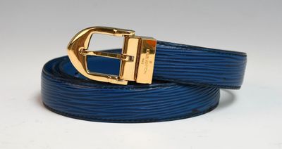a close up of a blue belt with a gold buckle