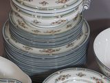 a lot of plates and bowls on the table