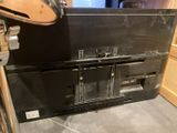 a black metal cabinet with a clock on top of it