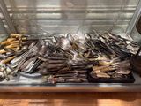 a display case filled with silverware and spoons