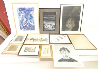 a lot of framed pictures on a table in a room