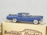 a blue toy car sitting on top of a box