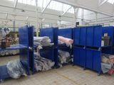 a large room filled with lots of blue bins