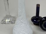 two vases and a bottle on the table