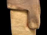 an image of a clay statue of a man ' s head on a black background